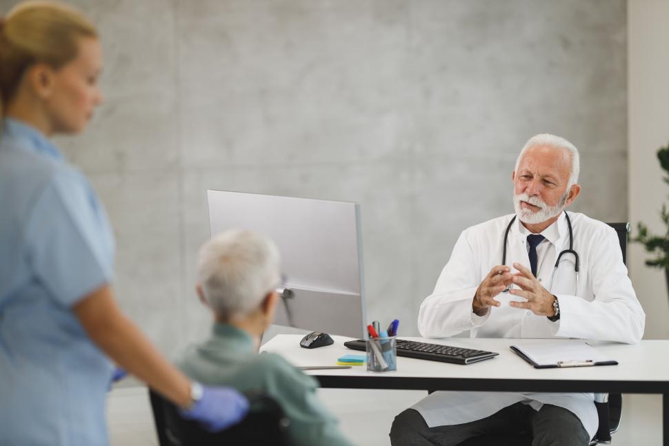 Free Image of Doctor with senior patient and nurse near PC 
