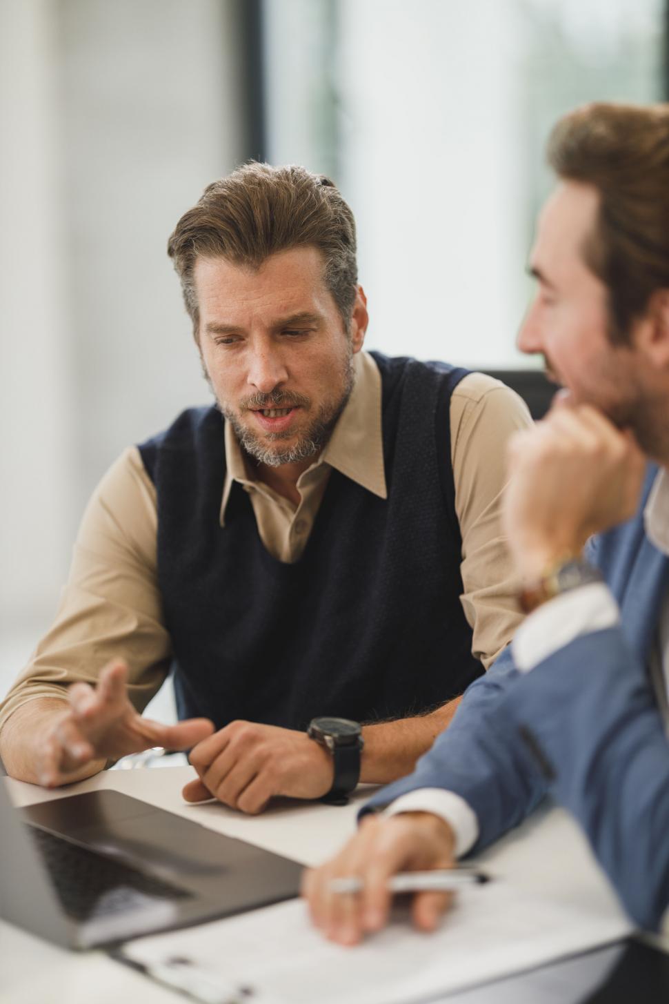 Free Image of Businessmen discussing over a laptop 