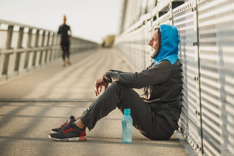 Free Image of Resting athlete on a bridge taking a break 