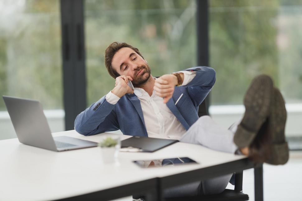 Free Image of Relaxed businessman with feet on the desk 