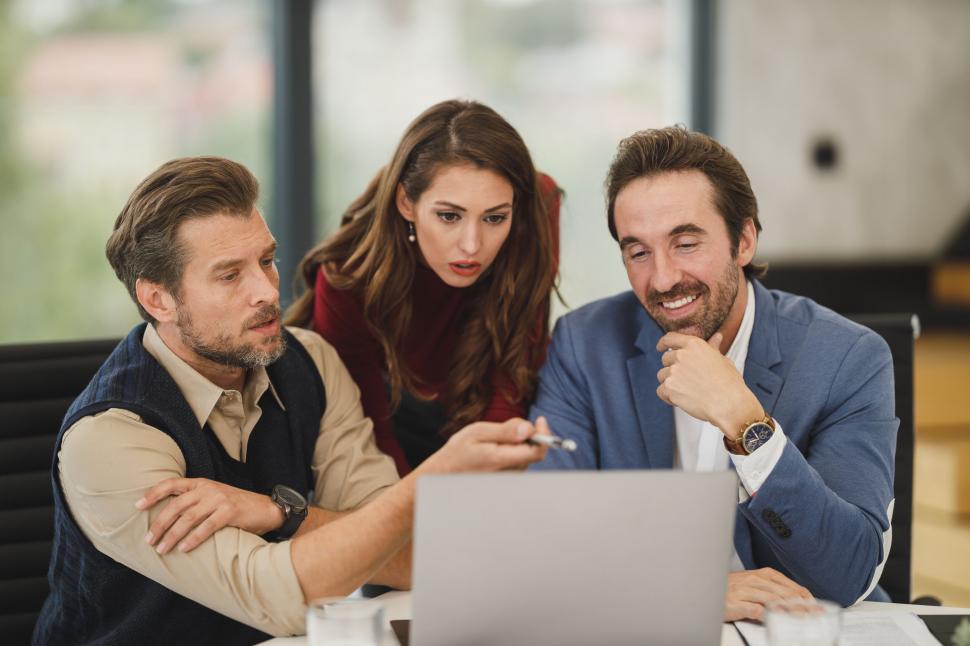 Free Image of Focused team analyzing data on laptop 