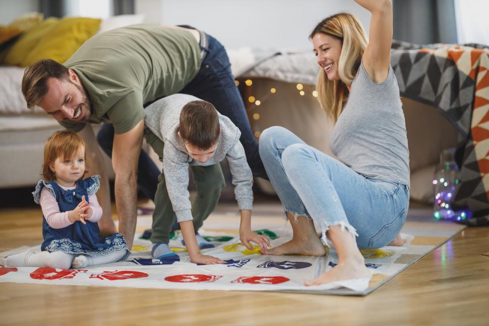 Free Image of Family playing on floor with children s game 