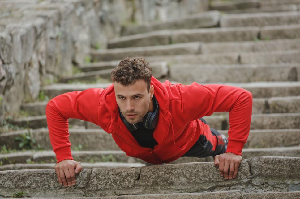 Free Image of Man doing push-ups on stone stairs 