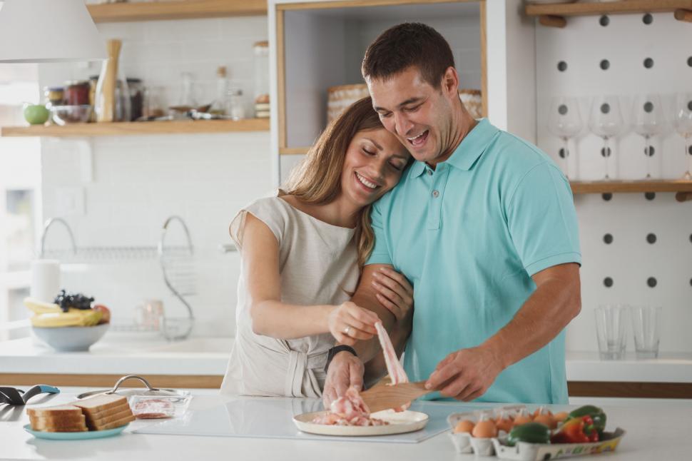 Free Image of Couple cooking together in home kitchen 