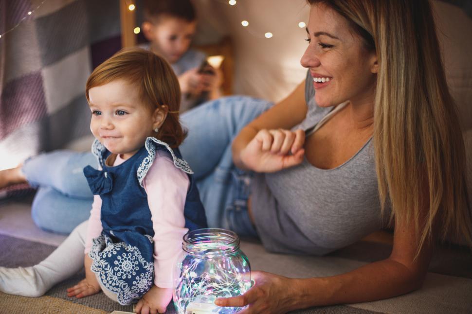 Free Image of Family playing with lights in cozy room 