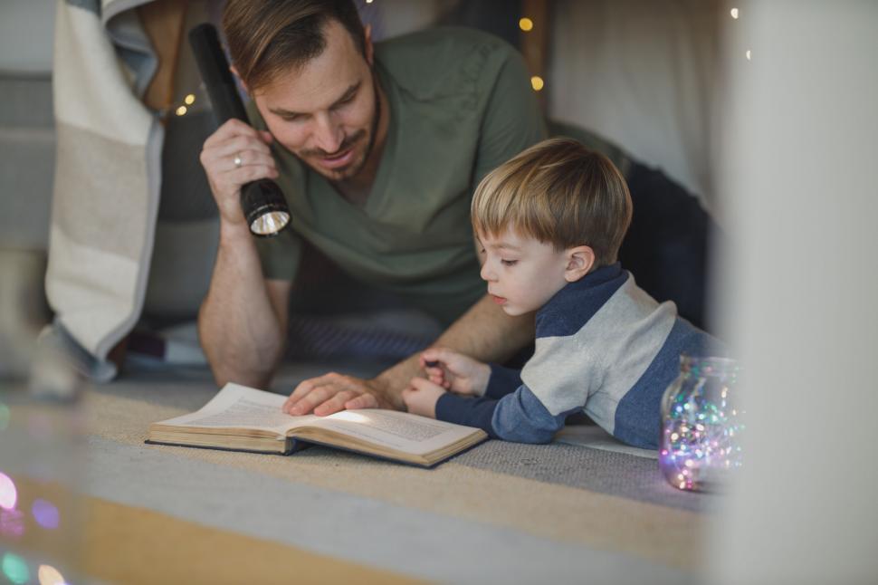 Free Image of Parent and child reading a book together 