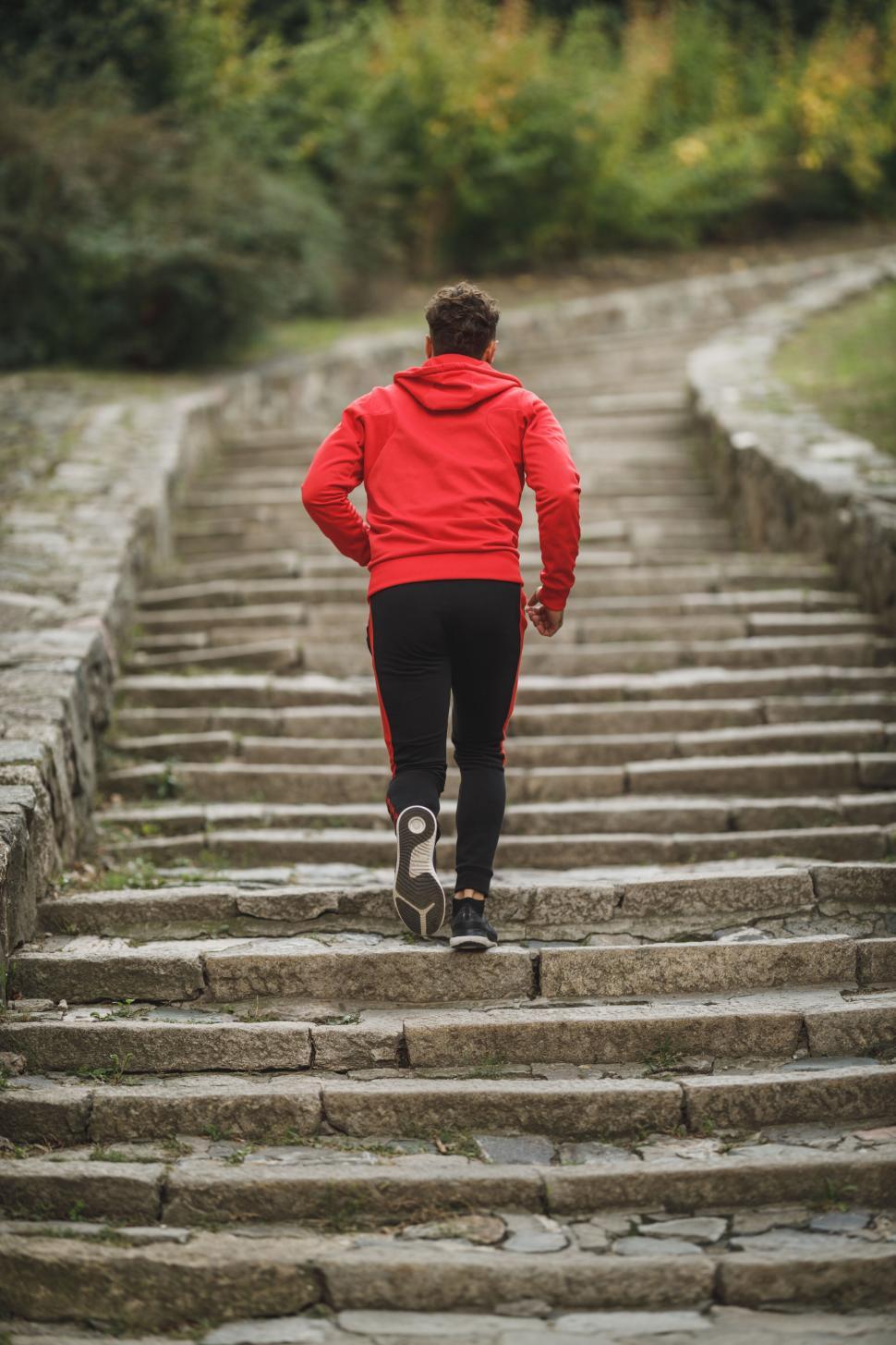 Free Image of Man climbing old stone stairway in park 