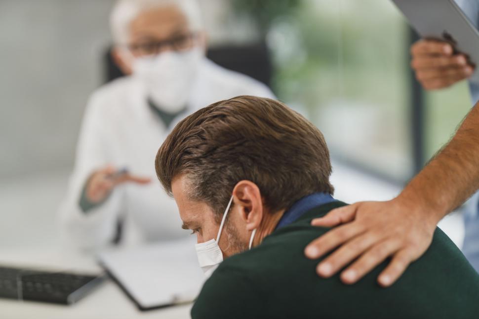 Free Image of Colleague consoling a stressed worker 