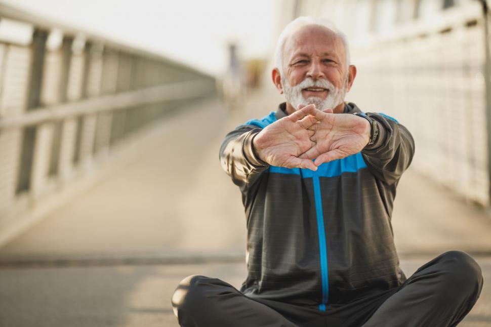 Free Image of Senior man doing yoga in urban setting 