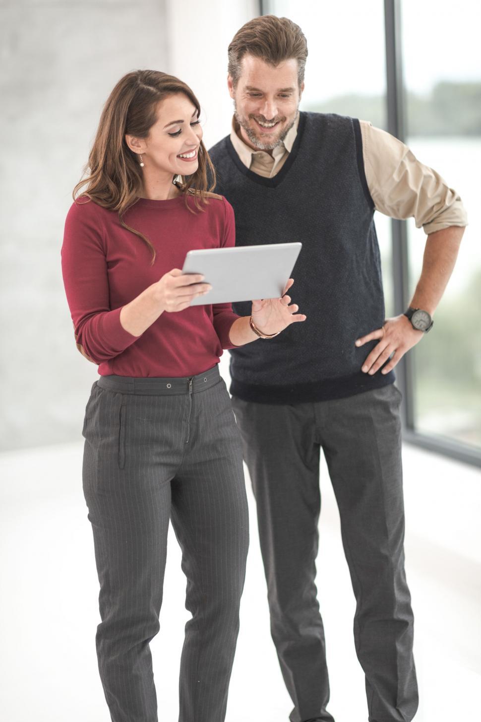 Free Image of Colleagues looking at tablet in office environment 