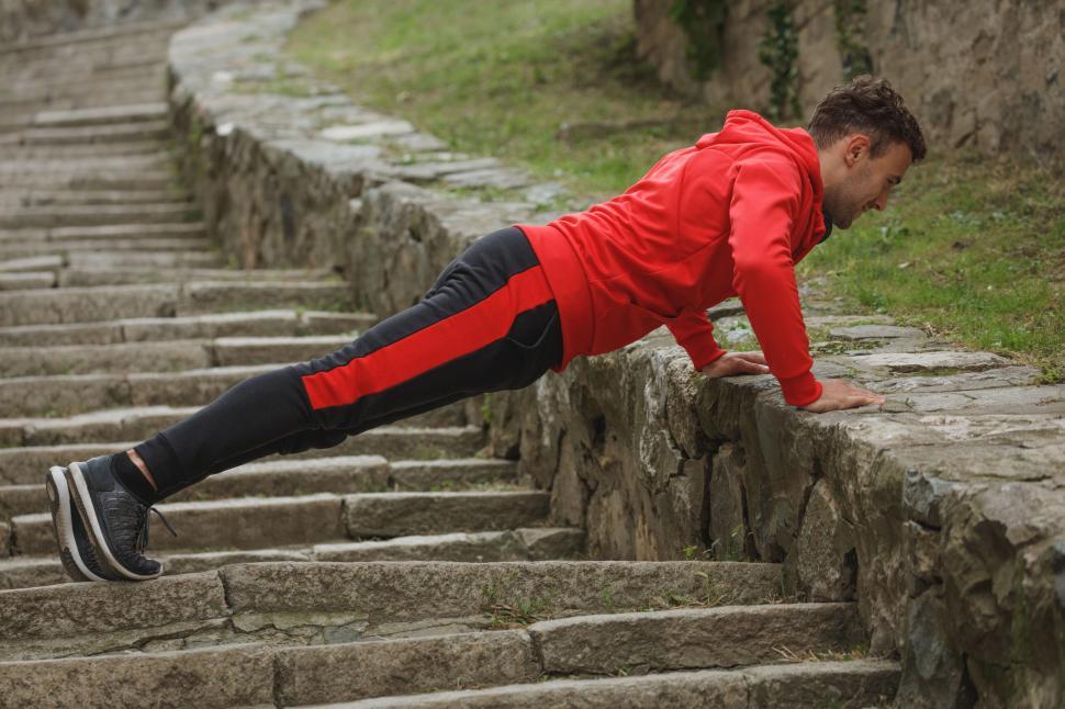 Free Image of Man doing push-ups on ancient stairs 