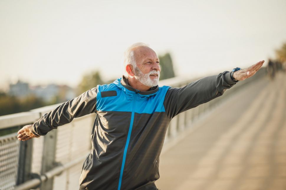 Free Image of Senior man exercising on city bridge 