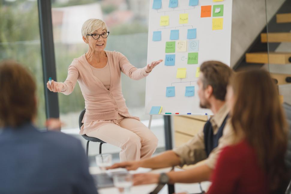 Free Image of Senior woman leading business meeting with team 