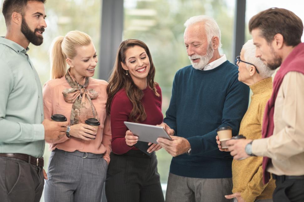 Free Image of Team members sharing a tablet with senior colleague 