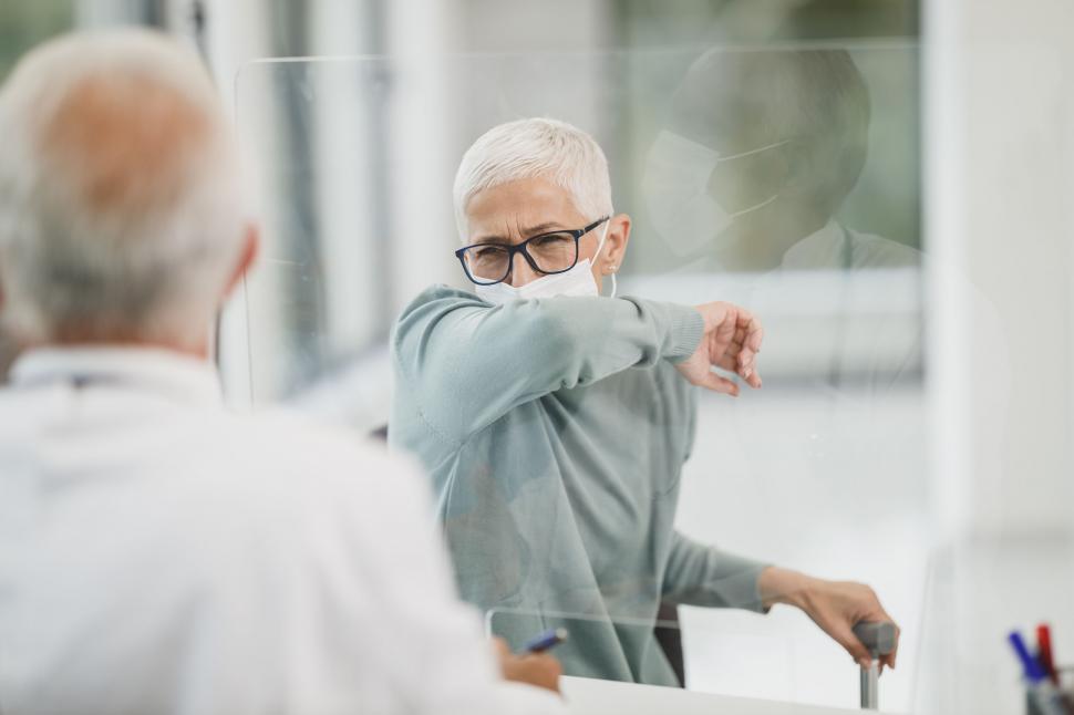Free Image of Senior man in a protective glass partition 