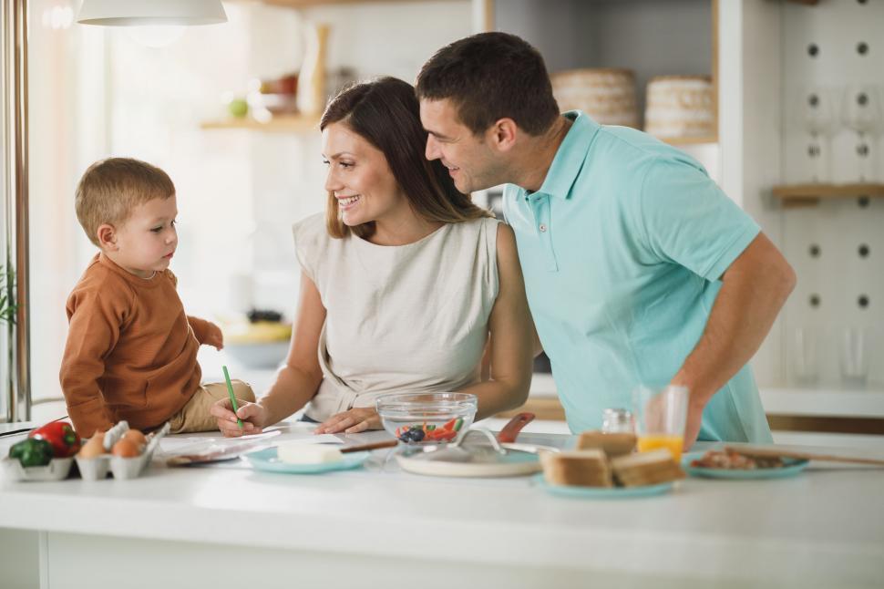 Free Image of Parents cooking with young son in kitchen 