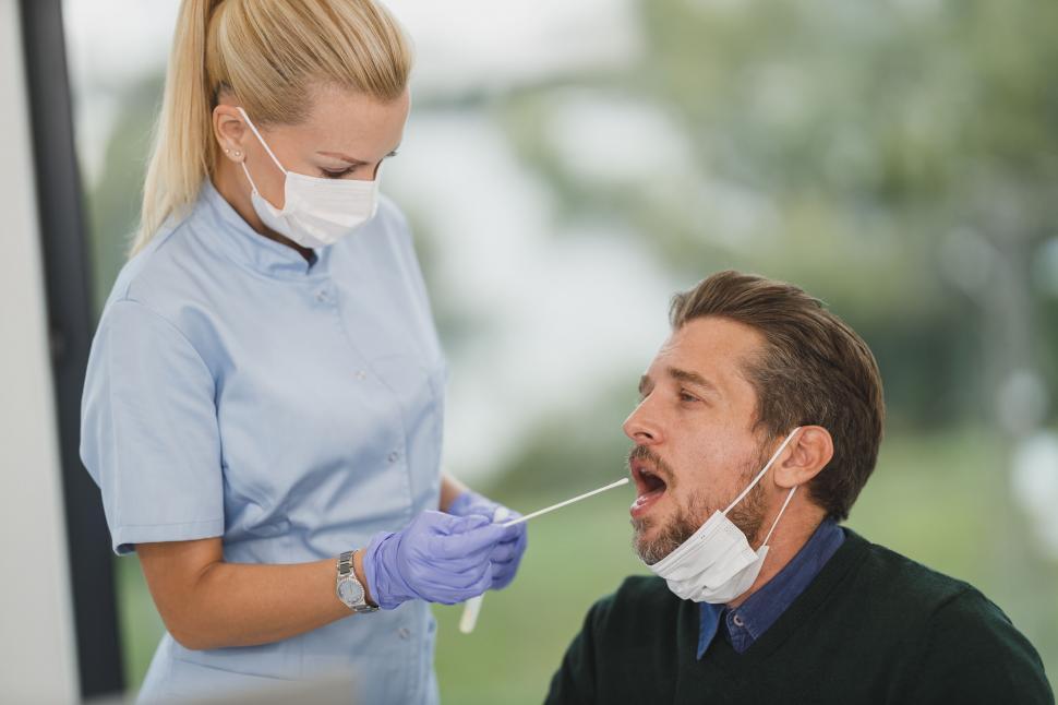 Free Image of Nurse performing COVID-19 test on patient 