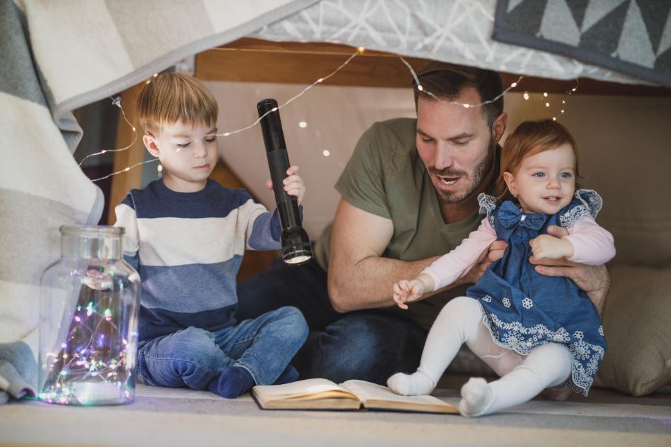 Free Image of Father and children in a homemade fort 
