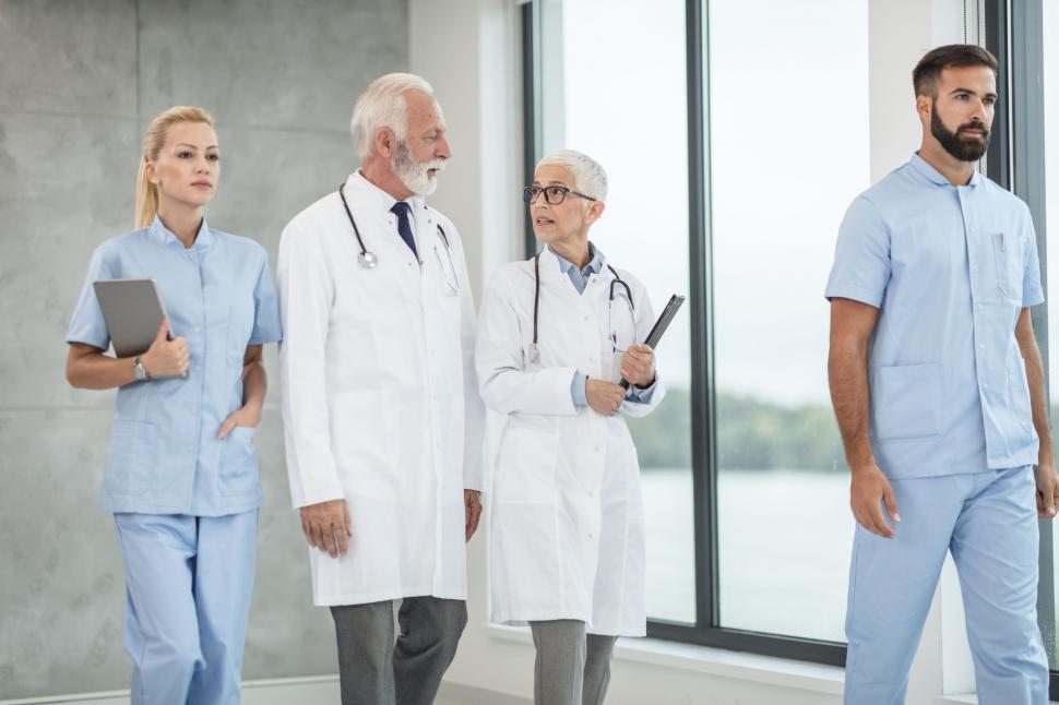 Free Image of Medical team walking in hospital corridor 