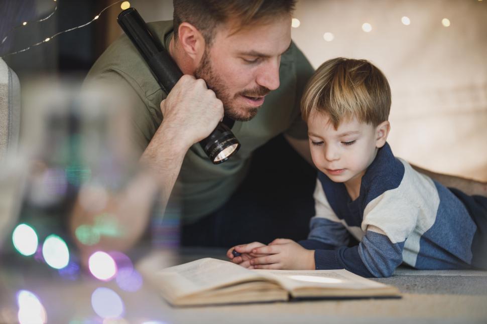Free Image of Father and son reading a book together 