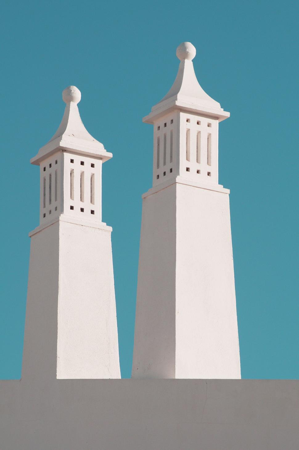 Free Image of Tall white towers against clear blue sky 