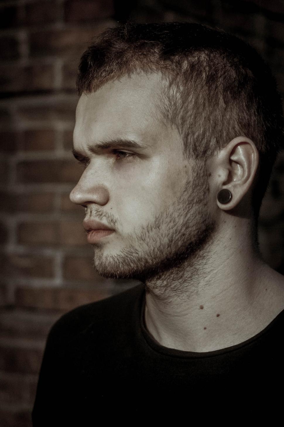 Free Image of Portrait of a man with an ear gauge 