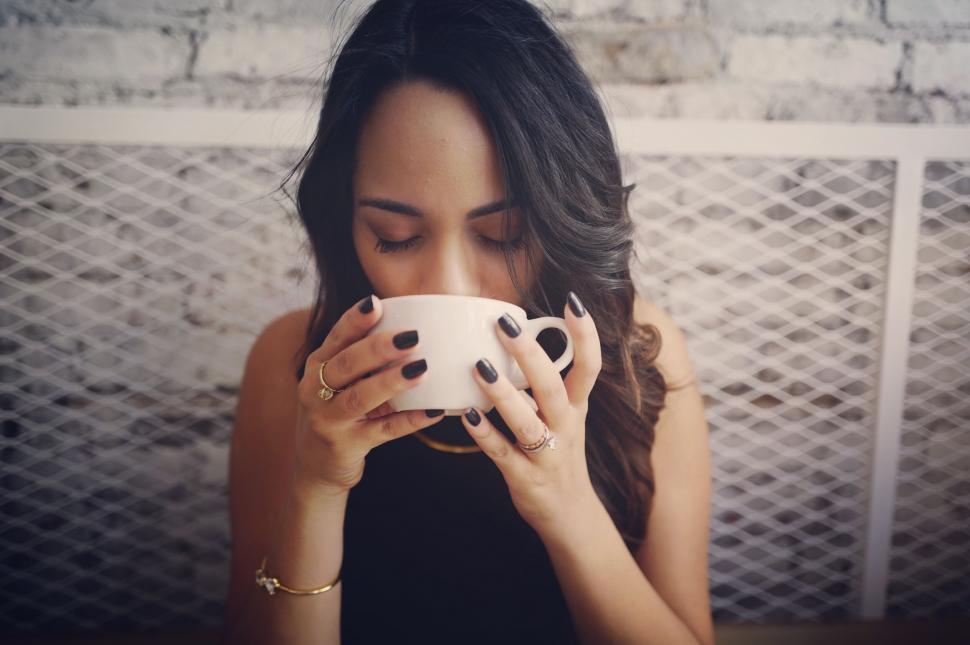 Free Image of Woman hiding face behind tablet menu 