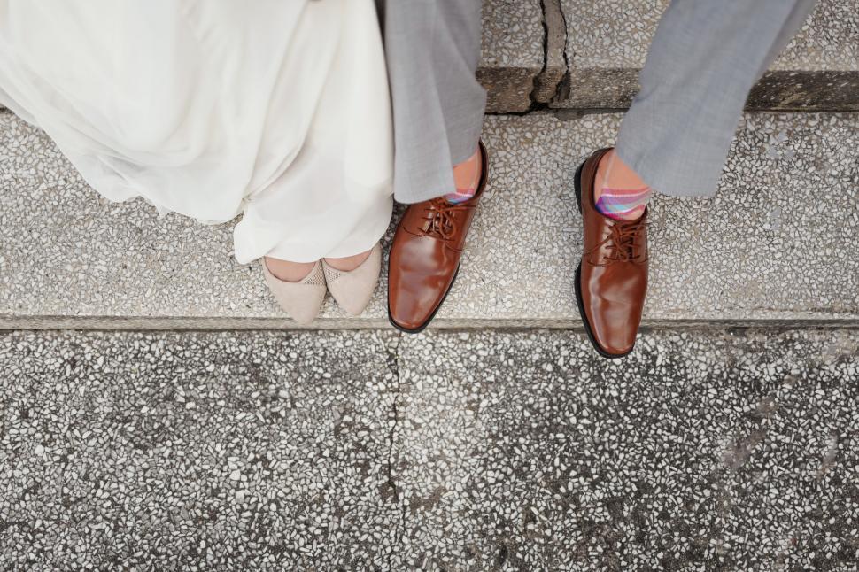 Free Image of Wedding couple s feet and hem of dress 