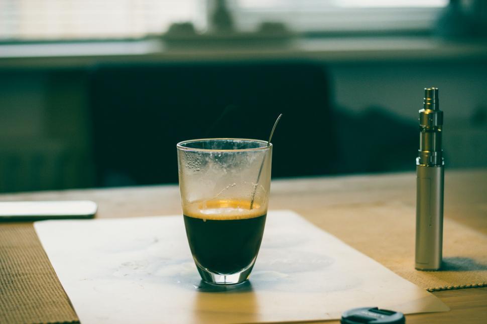 Free Image of Espresso coffee and e-cigarette on table 