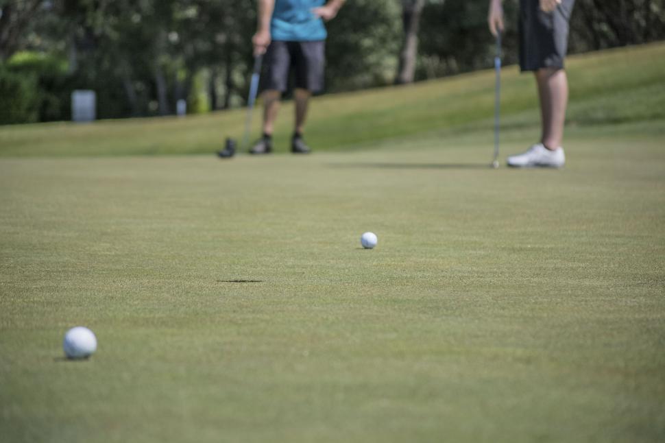 Free Image of Close-up of golf balls on putting green 