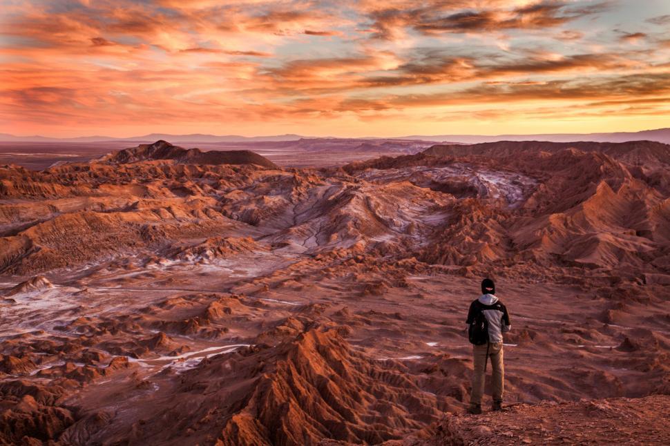 Free Image of Hiker overlooking a desert at sunset 