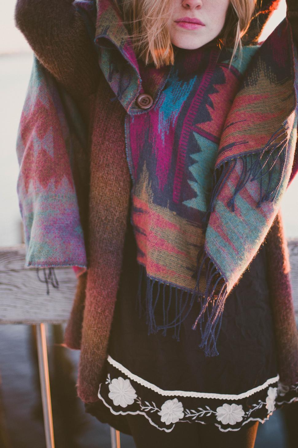 Free Image of Woman in colorful scarf near water 