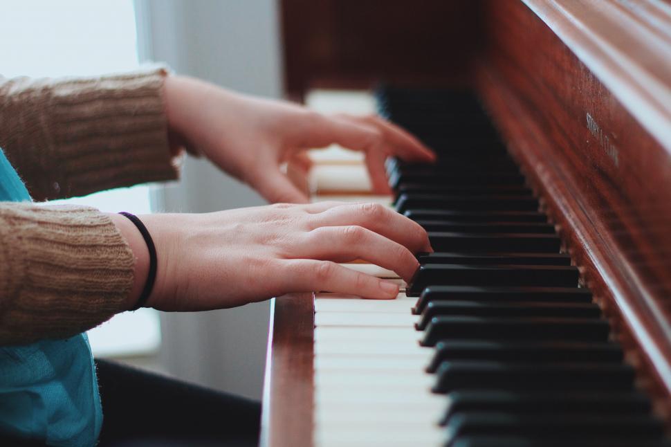 Free Image of Person playing on an old wooden piano 