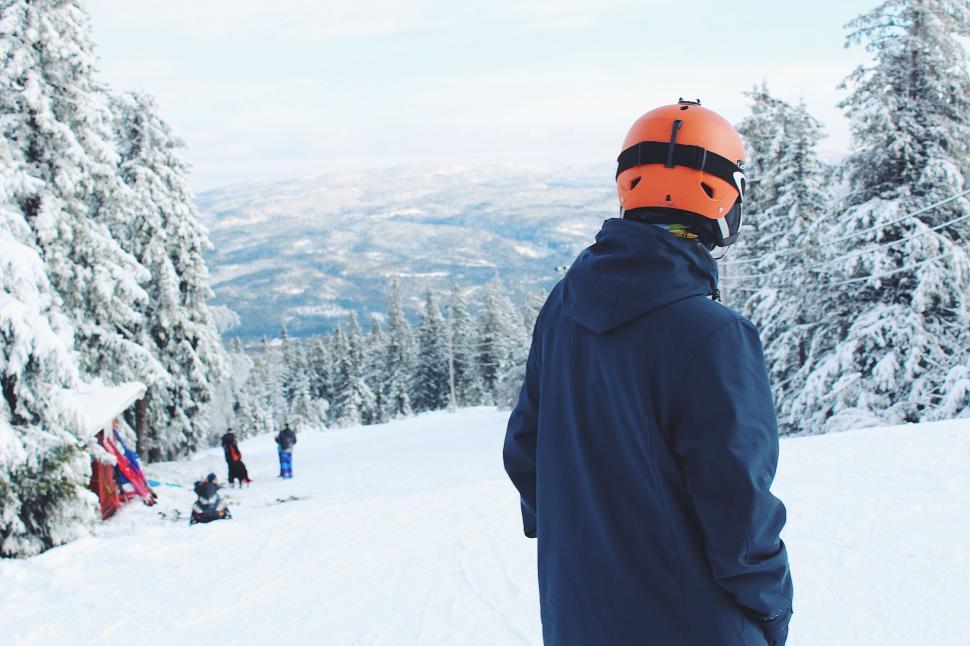 Free Image of Skier looking over snowy mountain landscape 