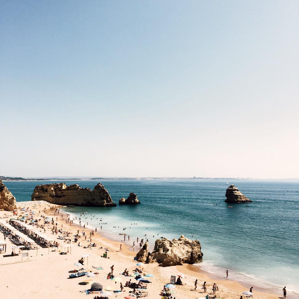 Free Image of Busy beach with iconic rock formations 