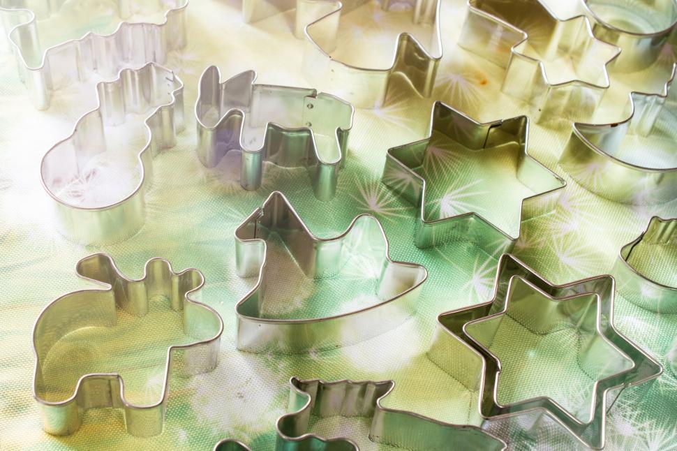 Free Image of Gleaming cookie cutters on a glass surface 
