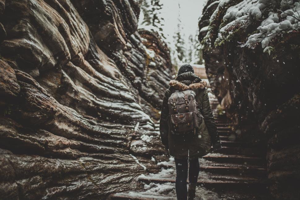 Free Image of Backpacker trekking a snowy canyon 