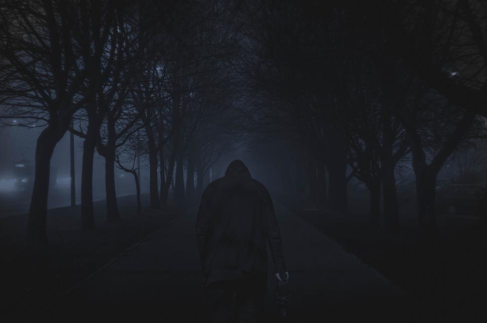 Free Image of Mysterious man walking alone in foggy park 