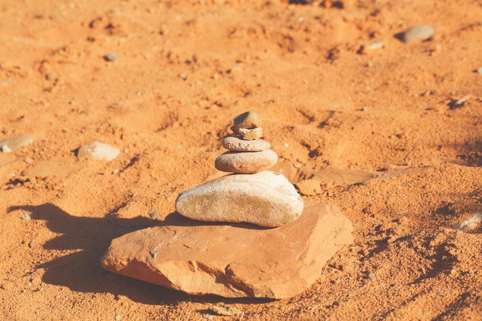 Free Image of Zen-like stack of stones on a sandy desert 