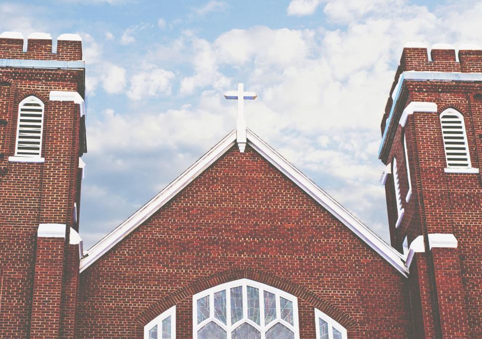 Free Image of Red brick church with a white cross on top 