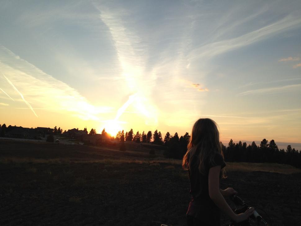 Free Image of Woman biking during sunset in countryside 