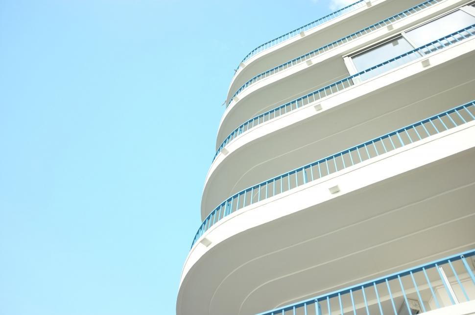 Free Image of Modern curvy white building against blue sky 