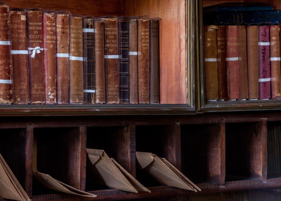 Free Image of Antique books in a wooden bookshelf 