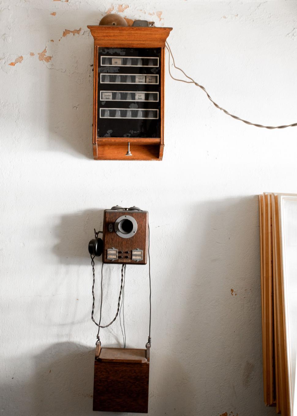 Free Image of Vintage telephone and cabinet on a wall 
