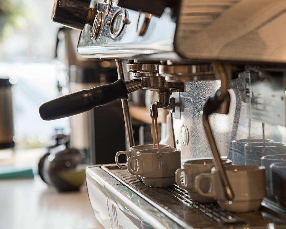 Free Image of Espresso pouring into white cups 