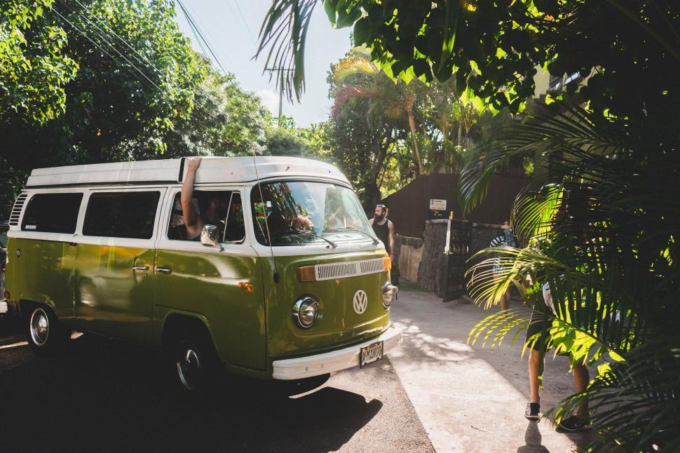 Free Image of Vintage green VW van cruising in nature 