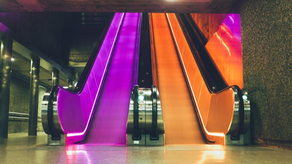Free Image of Vibrant escalator in purple and orange hues 