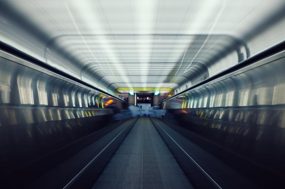 Free Image of Blurry motion of a moving escalator in a tunnel 