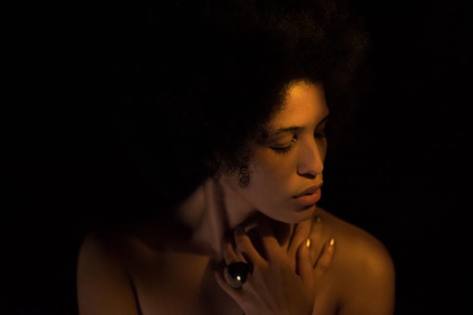 Free Image of Portrait of a woman in a dark setting 