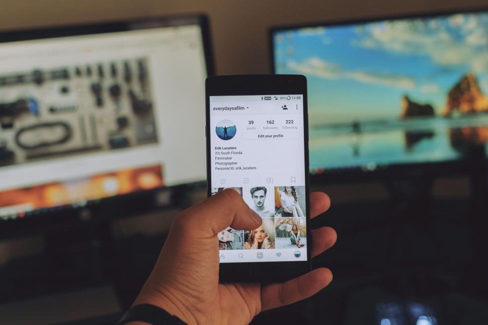 Free Image of Hand holding smartphone with social media 